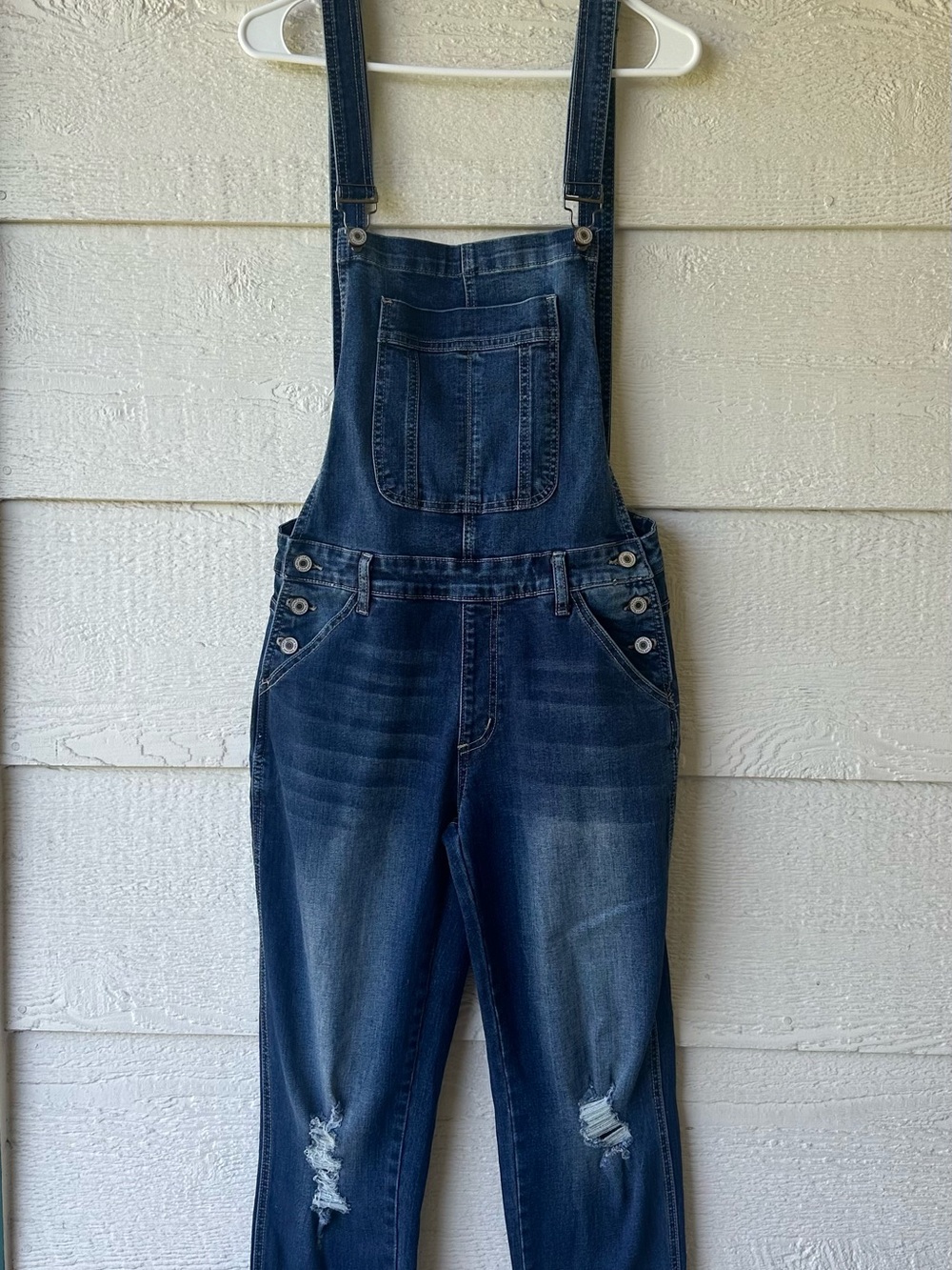 Distressed denim overalls
